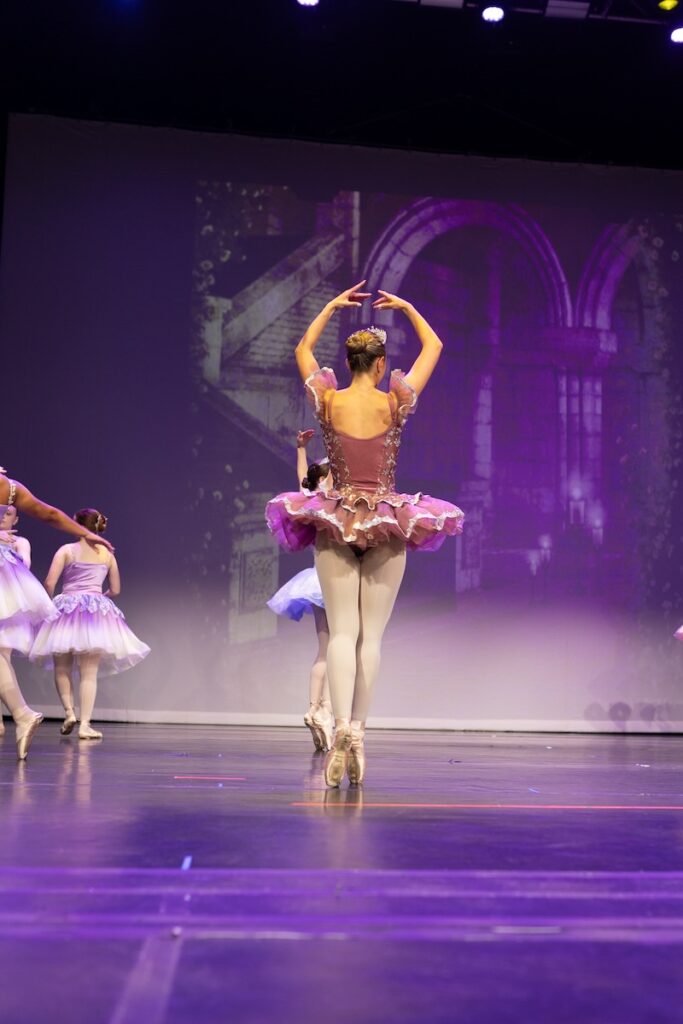 Young ballerina performing on stage.