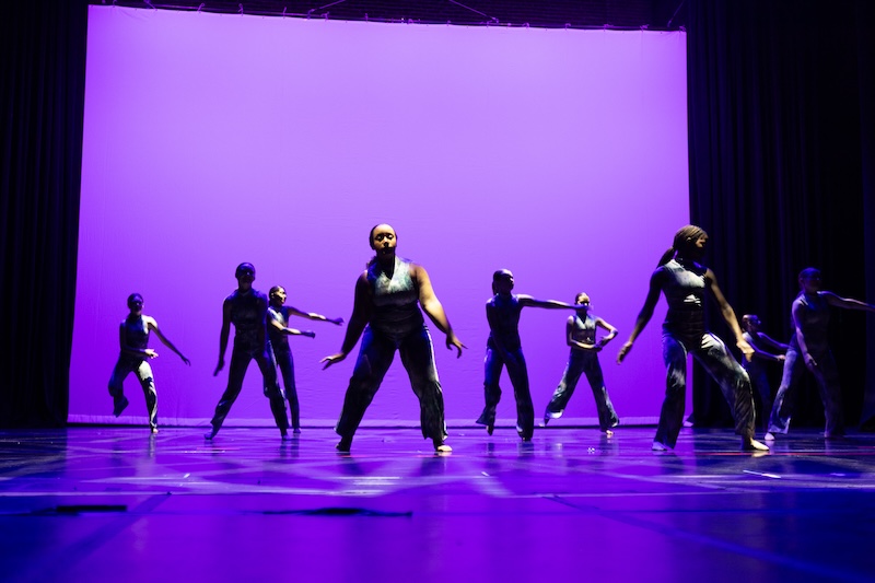 Modern dancers performing on stage.