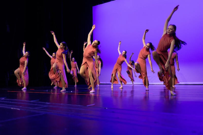Modern dancers performing on stage.