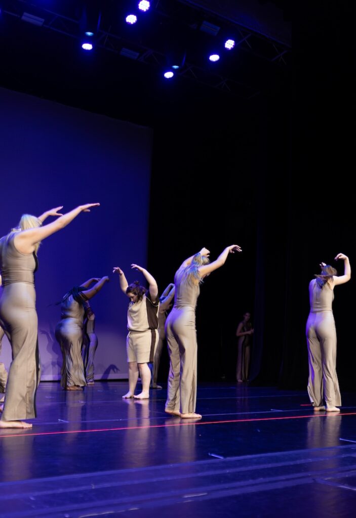 Modern dancers performing on stage.