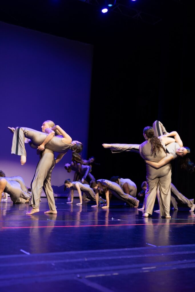 Modern dancers performing on stage.