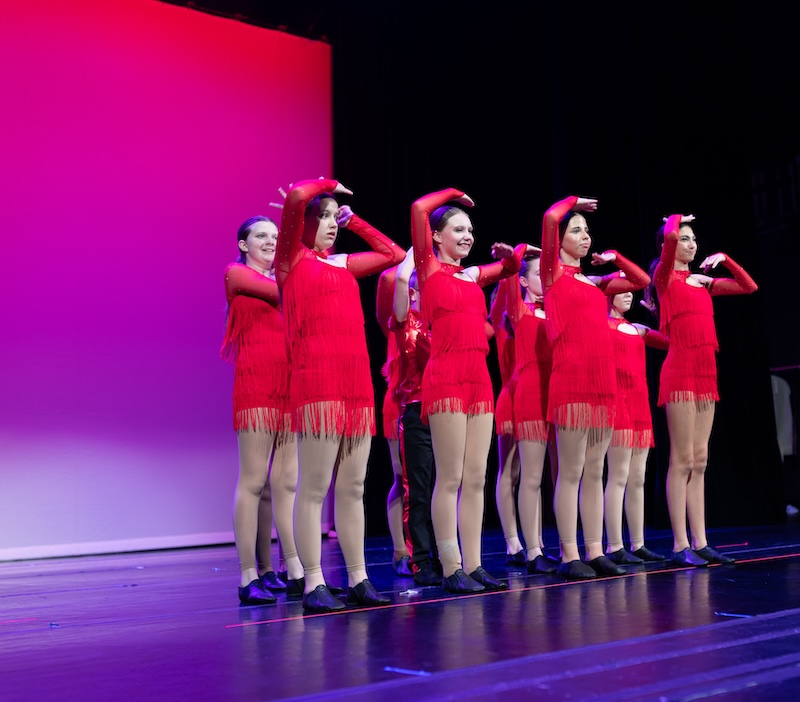 young jazz dancers performing on stage.