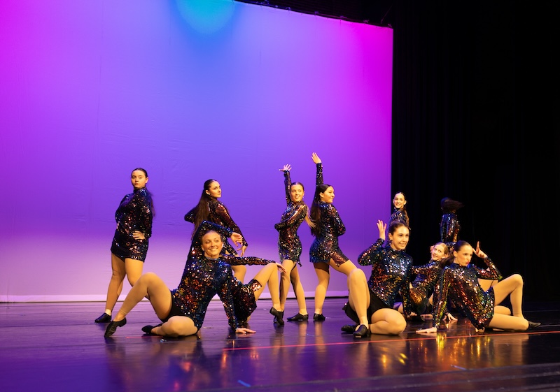 Jazz dancers posing on stage.