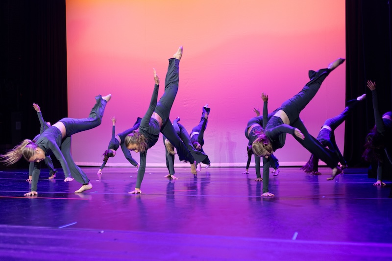 Modern dancers performing on stage.